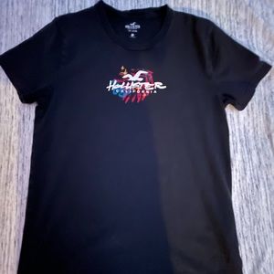 A black short sleeve tee from hollister CA made out of 100% cotton.